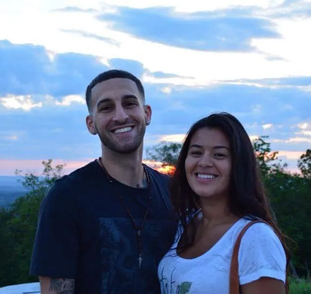 Anthony Capra smiling beside his partner at sunset